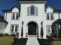 Close-up of the ornate black front door with decorative lights and a paved walkway at 3011 Flat Shoals Sw Rd, Conyers, GA 30094