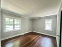 Bright bedroom featuring hardwood floors, freshly painted walls, and windows providing natural light at 6538 N Sweetwater Rd, Lithia Springs, GA 30122