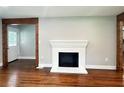 Cozy living room with a white painted fireplace and hardwood floors, perfect for relaxation and gatherings at 6538 N Sweetwater Rd, Lithia Springs, GA 30122