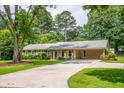 Beautiful single-story home with a well-maintained lawn, covered entry, and ample parking space on a paved driveway at 4150 Glenn St, Powder Springs, GA 30127