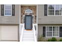 A close up of the home's front entry showcasing stone accents and crisp white stairs at 1087 Berkley Se Dr, Smyrna, GA 30082