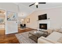 Open living room featuring a brick fireplace and seamless flow to the dining area at 1087 Berkley Se Dr, Smyrna, GA 30082