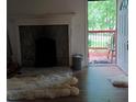 Living room with stone fireplace and access to a deck at 2463 Stone Rd, East Point, GA 30344