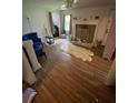 Open-concept living room with wood floors, a fireplace, and bright natural light at 2463 Stone Rd, East Point, GA 30344