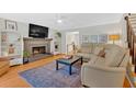 Inviting living room with a cozy fireplace, built-in bookshelves, and comfortable seating, perfect for relaxation and entertaining at 285 Sw Martin Sw Way, Marietta, GA 30064