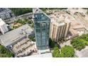 An aerial view showcasing a sleek modern building with high-rise apartments and a rooftop pool amenity at 3338 Peachtree Rd # 2005, Atlanta, GA 30326