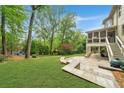 A lush backyard is complete with a stone patio, a built-in grill, and a large, well-maintained lawn perfect for outdoor activities at 3925 Sheldon Ne Dr, Atlanta, GA 30342