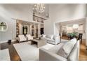 Bright, modern living room features soaring ceilings, large windows, and an open floor plan with views into the kitchen at 3925 Sheldon Ne Dr, Atlanta, GA 30342