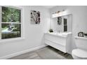Well-lit bathroom with a modern vanity, large mirror, and a view to the outside for a refreshing and serene experience at 82 Vanessa Se Dr, Smyrna, GA 30082