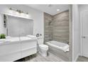 Bright bathroom featuring modern fixtures, a sleek vanity, tiled walls, and a separate tub-shower combination for relaxation at 82 Vanessa Se Dr, Smyrna, GA 30082