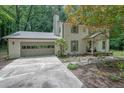 View of the exterior showcasing a two-story home with a well-maintained yard and attached garage at 82 Vanessa Se Dr, Smyrna, GA 30082
