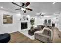 Inviting living room with a cozy fireplace, ceiling fan, and an open floor plan with modern decor and stylish furnishings at 82 Vanessa Se Dr, Smyrna, GA 30082