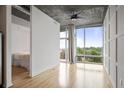 Open bedroom with floor to ceiling windows and hardwood floors at 943 Peachtree Ne St # 716, Atlanta, GA 30309