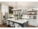 Bright kitchen with stainless steel appliances, a large island with seating, and ample cabinet space at 221 Brooke Dr., Alpharetta, GA 30009