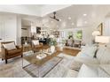 Open-concept living room featuring hardwood floors, a vaulted ceiling, and seamless flow to the dining area and kitchen at 221 Brooke Dr., Alpharetta, GA 30009