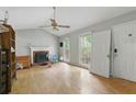 Bright living room featuring a fireplace, ceiling fan, and natural light at 4585 Muirwood Cir, Powder Springs, GA 30127