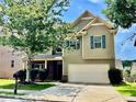 Charming two-story home with green siding, blue shutters, a two-car garage, and a well-maintained front yard at 3522 Fallen Oak Dr, Buford, GA 30519