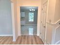 Inviting entryway with views into the kitchen featuring new flooring and a modern chandelier at 4284 Caroline Ct, Douglasville, GA 30135