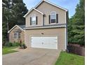 Side view of a charming two-story home with a two-car garage and manicured front lawn at 4284 Caroline Ct, Douglasville, GA 30135