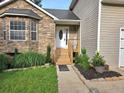Charming home entrance with stone accents, a welcoming porch, and tidy landscaping at 4284 Caroline Ct, Douglasville, GA 30135