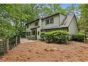 Landscaped backyard with black iron fence, patio and mature trees offering privacy and outdoor enjoyment at 6100 Blackwater Trl, Atlanta, GA 30328