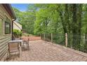 Paver patio offering an outdoor seating area and views of the beautifully wooded surroundings at 6100 Blackwater Trl, Atlanta, GA 30328