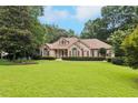 Classic brick home with manicured lawn, providing a welcoming and picturesque view at 8110 Lakemont Close, Mcdonough, GA 30253