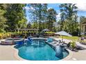 An inviting in-ground pool with a spa, water features, and plenty of room for entertaining at 3111 Old Thompson Mill Rd, Buford, GA 30519