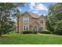 Two story home with a landscaped yard and a bright teal front door sits on a manicured lawn at 1850 Thomas Ne Dr, Marietta, GA 30066