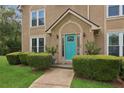 Close up of bright teal front door framed by manicured landscaping and a stone walkway at 1850 Thomas Ne Dr, Marietta, GA 30066