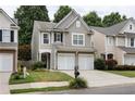 Attractive two-story home featuring neutral siding, a well-kept lawn, and a convenient two-car garage at 303 Barberry Pl, Canton, GA 30114