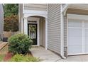 Inviting front door with decorative wreath, framed by a covered porch and lush landscaping at 303 Barberry Pl, Canton, GA 30114