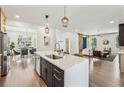 Modern kitchen featuring a large island with a sink and open sightlines to the living and dining areas at 3087 Alston Dr, Decatur, GA 30032