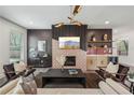 Beautiful living room with a modern fireplace, accent wall, and views to the green outdoors through the windows at 3087 Alston Dr, Decatur, GA 30032