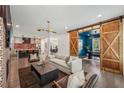 Open concept living room and kitchen area featuring hardwood floors and a sliding barn door at 3087 Alston Dr, Decatur, GA 30032