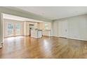 Bright, open living space with hardwood floors, french doors, and view of kitchen at 511 Ashburton Ave, Decatur, GA 30032