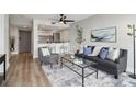 Inviting living room with modern decor, luxury flooring, and an open layout to the kitchen at 1280 W Peachtree Nw St # 2205, Atlanta, GA 30309