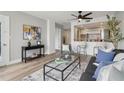 Cozy living room featuring a gray accent chair, an open layout to the kitchen, and a ceiling fan at 1280 W Peachtree Nw St # 2205, Atlanta, GA 30309
