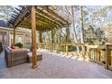 Inviting back deck with wooden pergola, outdoor seating, and a serene backyard view at 656 Gunby Se Rd, Marietta, GA 30067