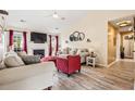Cozy living room featuring wood floors, a fireplace, and stylish furnishings at 1543 Blossom Dr, Atlanta, GA 30349
