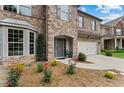 Close-up of a brick home featuring manicured lawn and two chairs at the front door at 3547 Edenridge Ct, Buford, GA 30519