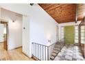 Bright entryway features hardwood floors, wood-paneled ceiling and front door at 3861 Foxford Dr, Atlanta, GA 30340