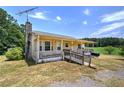 Inviting home with a covered front porch and mature trees, perfect for relaxing outdoors at 668 Spring Place Ne Rd, White, GA 30184