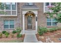 Inviting front entrance with detailed trim and neatly landscaped garden beds at 2530 Clairebrooke Bend, Atlanta, GA 30341