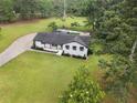Aerial view of a single-Gathering home, black roof, white paint, and an in-ground pool at 2827 Highway 138 Ne, Conyers, GA 30013