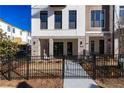 Charming townhome with brick accents, black-framed windows, and an inviting entrance with wrought iron fencing at 350 Olmstead Way # 29, Alpharetta, GA 30022