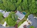 Aerial view of a beautiful home nestled among lush trees with a private pool at 1488 Lachona Ne Ct, Atlanta, GA 30329
