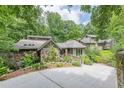 Beautiful exterior with stone accents, lush greenery, and a private driveway at 1757 E Clifton Ne Rd, Atlanta, GA 30307