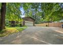 Spacious driveway leading to a detached garage on a property with mature trees at 267 Firecreek Rdg, Lawrenceville, GA 30046