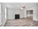 Bright living room featuring a fireplace, hardwood flooring, and neutral walls at 5380 Bridle Point Pkwy, Snellville, GA 30039